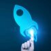 A hand pointing at a blue rocket icon on a dark background, symbolizing innovation or technology.