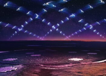 A series of satellites arranged in a grid pattern above a field during twilight.