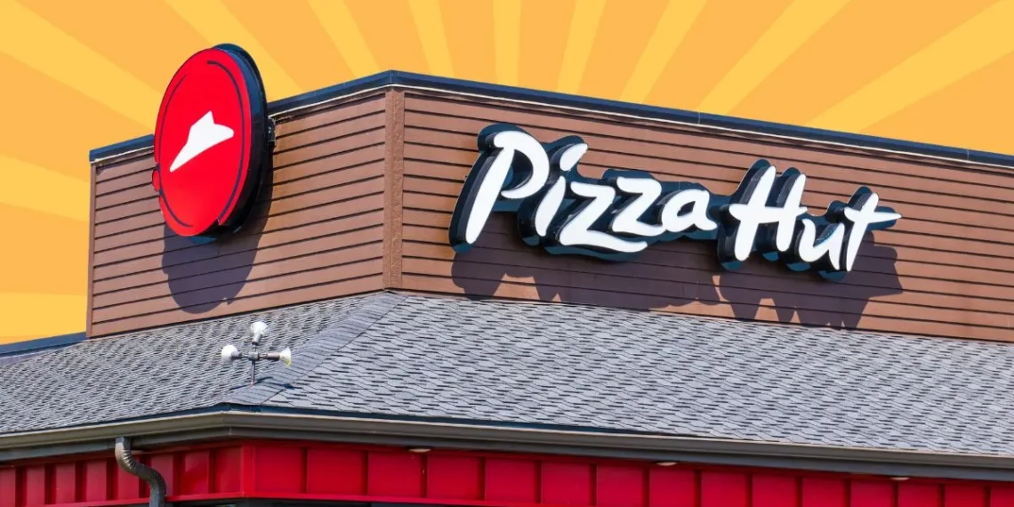 Pizza Hut restaurant exterior featuring the logo and signage on a building.