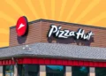 Pizza Hut restaurant exterior featuring the logo and signage on a building.