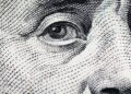 Close-up view of Benjamin Franklin's face on a one hundred dollar bill.