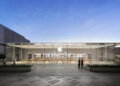 Exterior view of an Apple Store featuring a glass facade and the Apple logo.