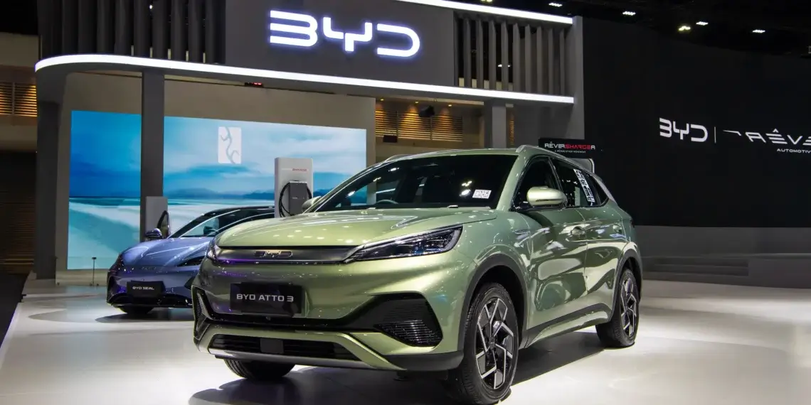 BYD Atto 3 electric SUV displayed at an auto show with a modern design and green color.