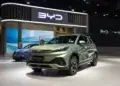 BYD Atto 3 electric SUV displayed at an auto show with a modern design and green color.