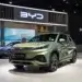 BYD Atto 3 electric SUV displayed at an auto show with a modern design and green color.