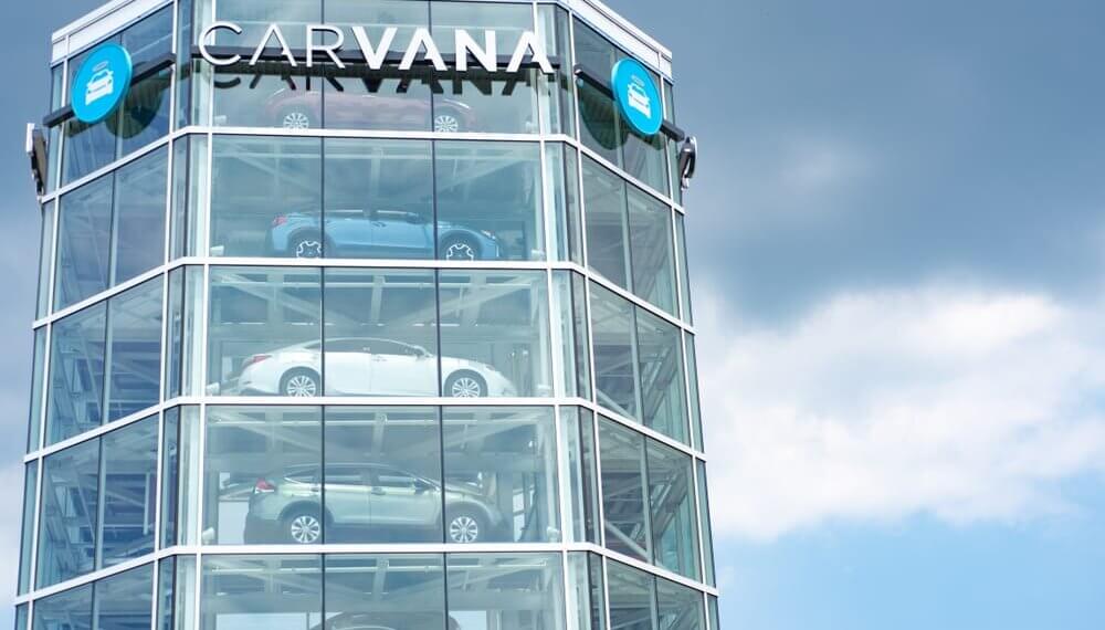 Carvana vehicle vending machine displaying multiple cars in a glass structure.