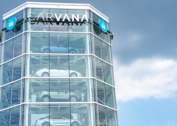 Carvana vehicle vending machine displaying multiple cars in a glass structure.
