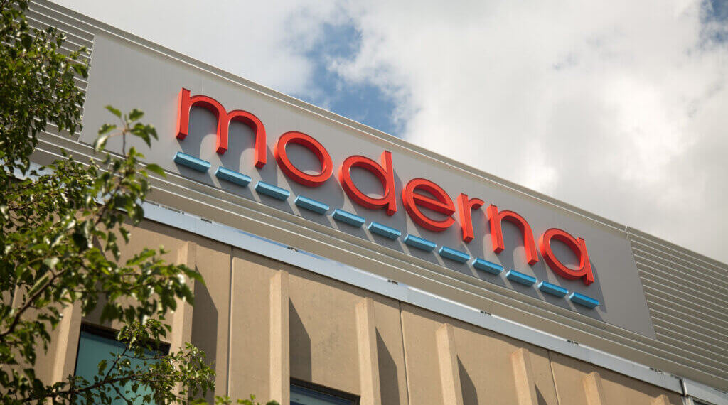 Sign with the word 'moderna' in red and blue letters on a building exterior.
