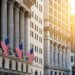 Exterior view of the New York Stock Exchange building featuring American flags.