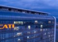 Exterior view of the CATL corporate building illuminated at dusk with the company logo visible.