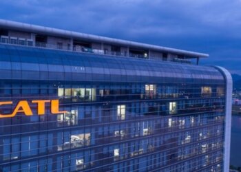 Exterior view of the CATL corporate building illuminated at dusk with the company logo visible.