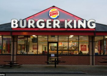 Exterior view of a Burger King restaurant with its logo prominently displayed on the roof.