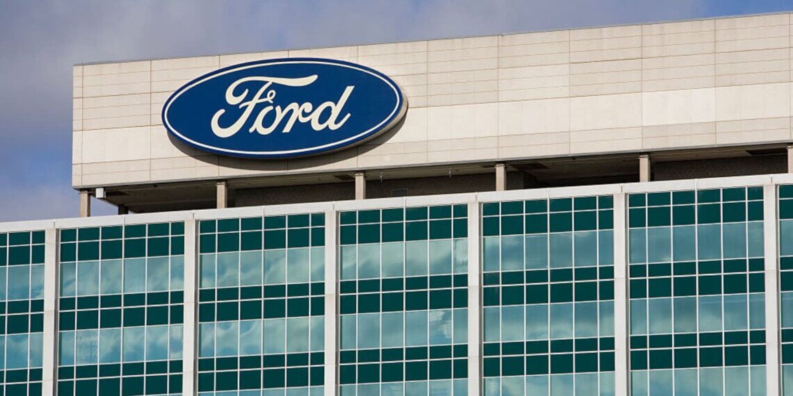 Exterior view of the Ford Motor Company headquarters building with the Ford logo on display.