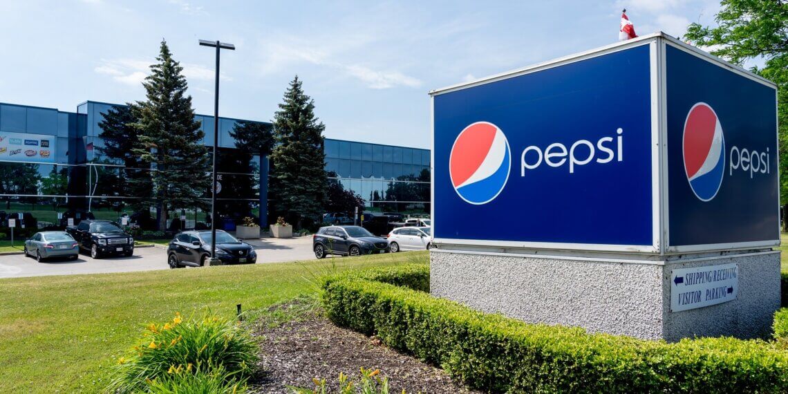 PepsiCo sign in front of a facility with cars parked outside in Canada.