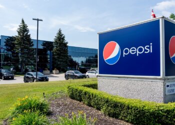 PepsiCo sign in front of a facility with cars parked outside in Canada.