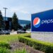 PepsiCo sign in front of a facility with cars parked outside in Canada.