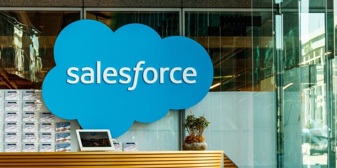 Salesforce logo displayed prominently at a reception area with a wooden counter.