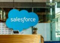 Salesforce logo displayed prominently at a reception area with a wooden counter.