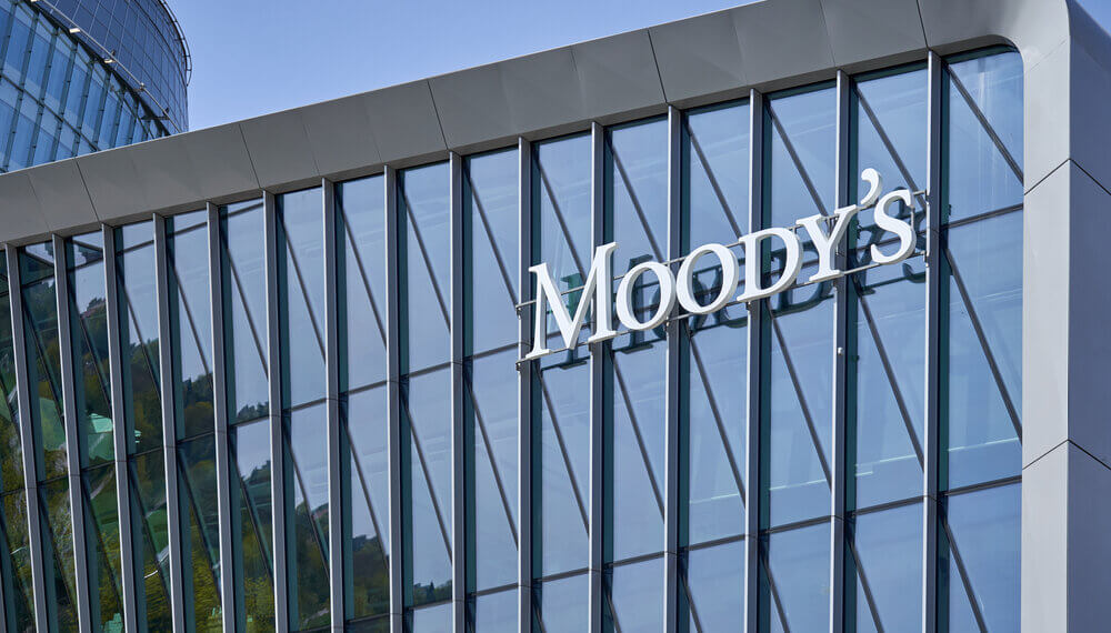 Modern glass building facade with the Moody's logo prominently displayed.