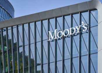 Modern glass building facade with the Moody's logo prominently displayed.