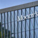 Modern glass building facade with the Moody's logo prominently displayed.
