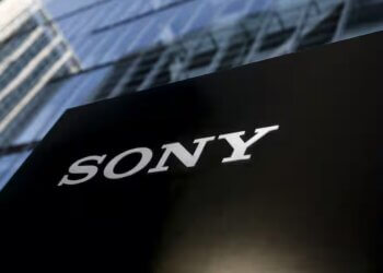 Black sign with the white Sony logo displayed prominently in front of a glass building.