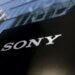Black sign with the white Sony logo displayed prominently in front of a glass building.