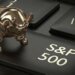 A golden bull figurine positioned on a black keyboard key labeled S&P 500.
