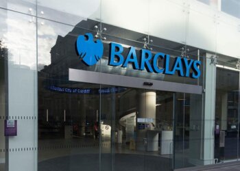 Entrance of a Barclays Bank branch featuring the logo and glass facade.