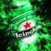 Heineken beer bottle with a green and black abstract background effect.