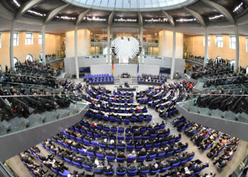 Interior view of the German Bundestag Plenary Hall with seating and a central stage.