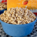 A blue bowl filled with Honey Nut Cheerios cereal on a textured surface.