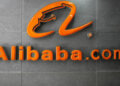 Orange Alibaba.com logo displayed on a gray wall with a modern design.
