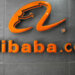 Orange Alibaba.com logo displayed on a gray wall with a modern design.