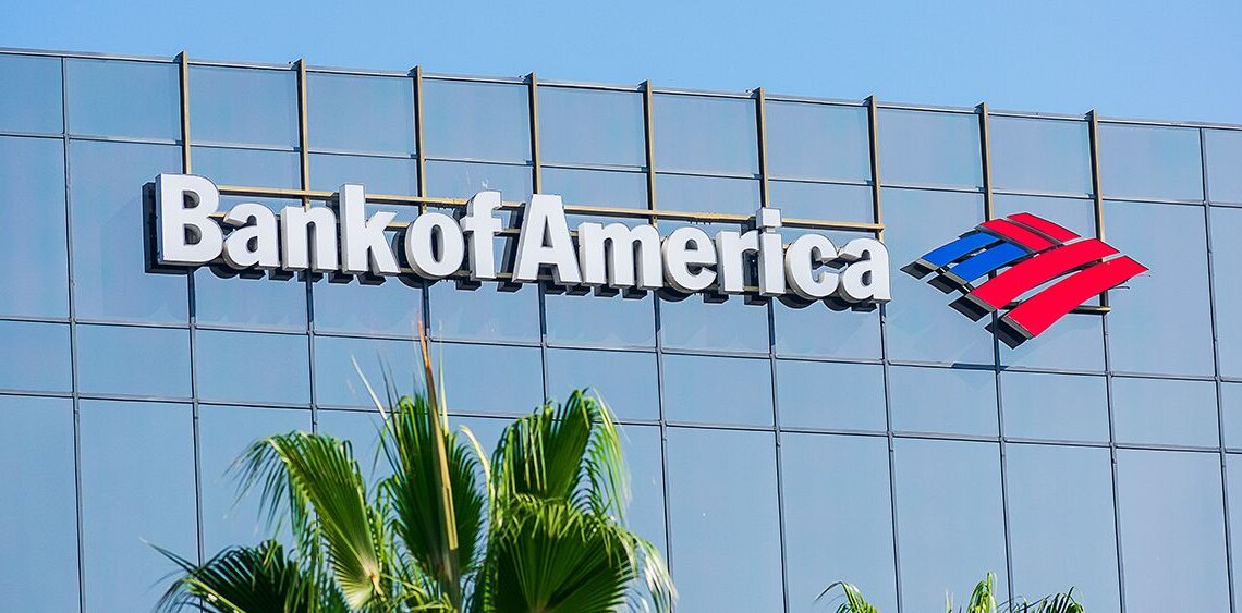 Bank of America logo displayed on the exterior of a building with palm trees in the foreground.
