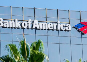 Bank of America logo displayed on the exterior of a building with palm trees in the foreground.