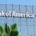 Bank of America logo displayed on the exterior of a building with palm trees in the foreground.