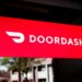Red sign displaying the DoorDash logo with a stylized delivery icon.