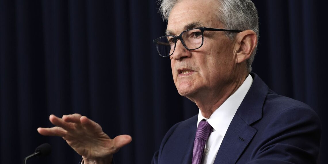 Jerome Powell, the Chair of the Federal Reserve, speaking at a press conference with a serious expression.