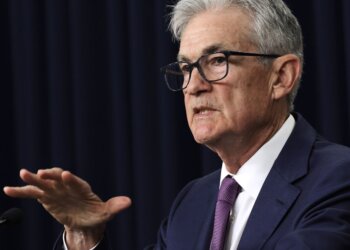 Jerome Powell, the Chair of the Federal Reserve, speaking at a press conference with a serious expression.