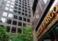 Wells Fargo bank signage displayed on a building with reflective glass windows.