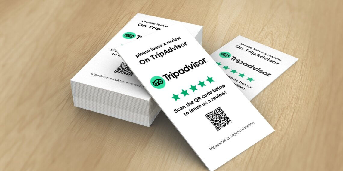 Stack of cards with a QR code and instructions to leave a review on Tripadvisor.