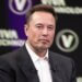 Elon Musk seated on stage during the Viva Technology conference with a serious expression.