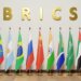 Flags of BRICS countries including Brazil, Russia, India, China, and South Africa arranged in a row.