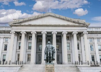 U.S. Treasury Department building featuring a statue of Robert Morris in front.