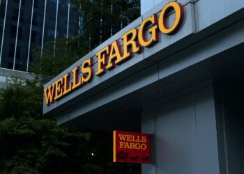 Wells Fargo signage displayed on the exterior of a building with a red and yellow color scheme.