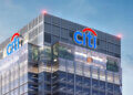 Citi Bank building with prominent logo displayed on the upper facade against a clear sky.
