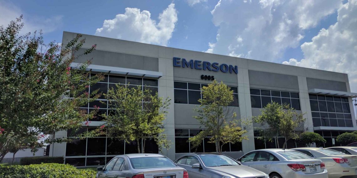 Exterior view of the Emerson corporate office building with a clear sky and parked cars.