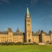 The Centre Block of Parliament Hill in Ottawa, Ontario, featuring a clock tower and Gothic architectural style.