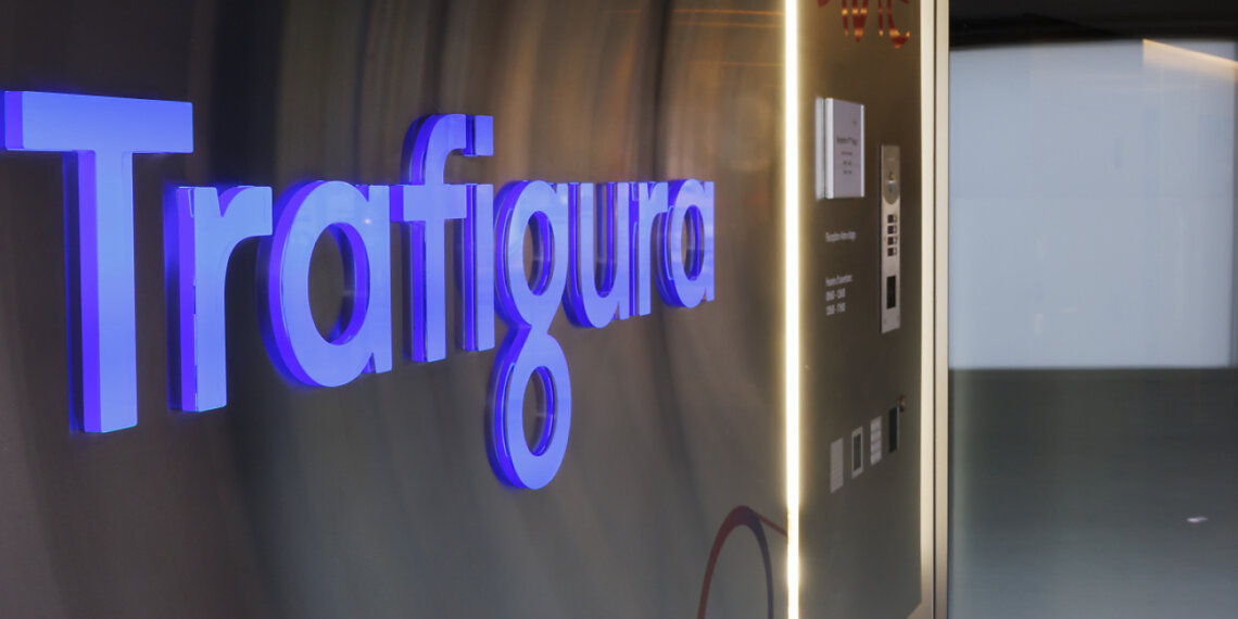 Illuminated sign displaying the name 'Trafigura' in a modern office setting.